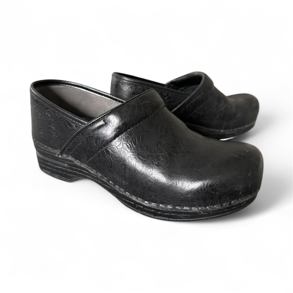 Women’s Dansko Black Floral Embossed Clogs